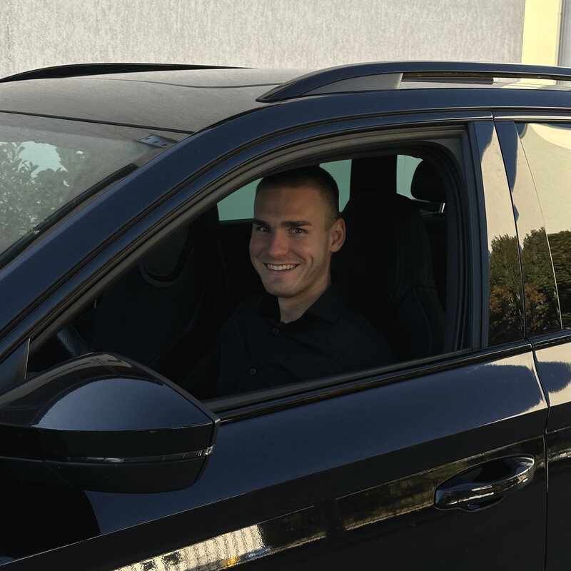 Krisztián seated in his Škoda Superb